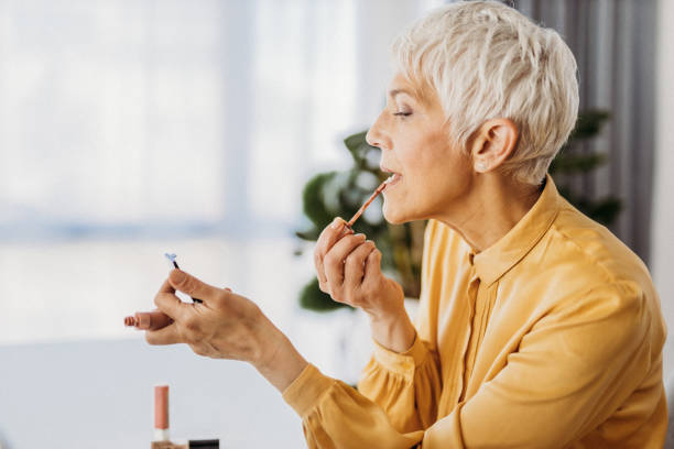 Mature lady testing lipstick shades